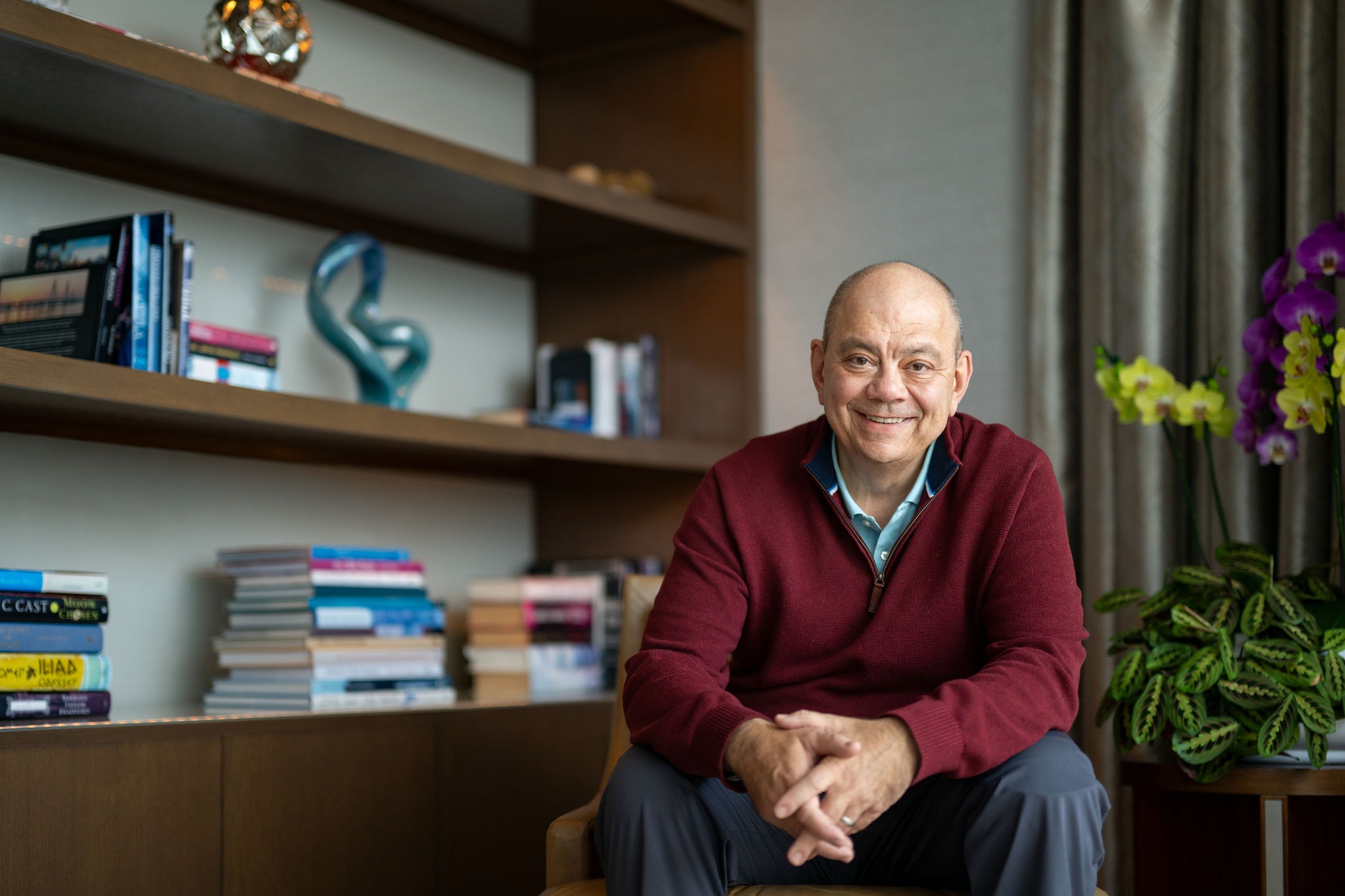 Scott Ferguson smiles indoors in front of a bookshelf. 